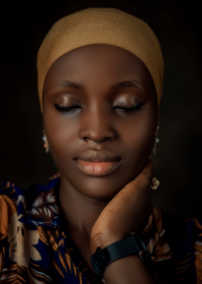 Crafting Captivating Headlines: Your awesome post title goes here Serene close-up portrait of a woman with closed eyes and a headscarf.